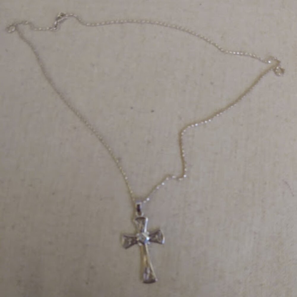 Silver cross on chain necklace.
